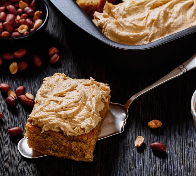 Ein Stück Erdnussbutter-Kuchen auf einem Tortenheber. | © EAT CLUB / Isabell Triemer