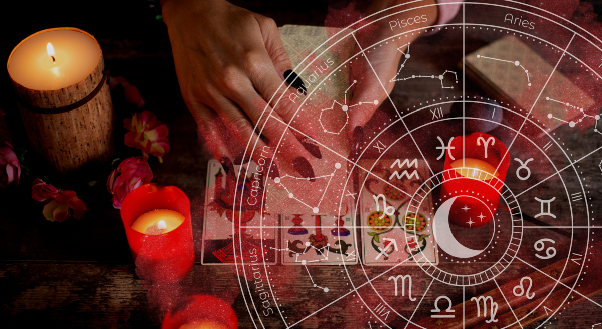 Hand einer Frau mit astrologischen Zeichen im Hintergrund.