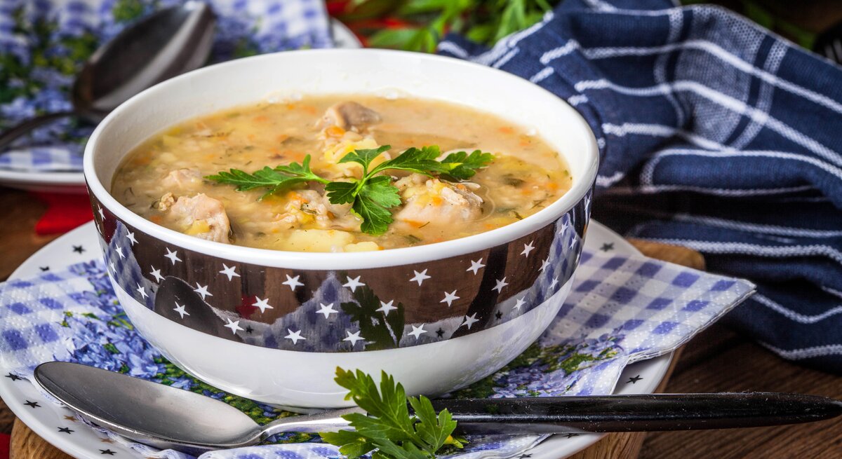 Kitschige Suppenschüssel gefüllt mit einer polnischen Graupensuppe. 