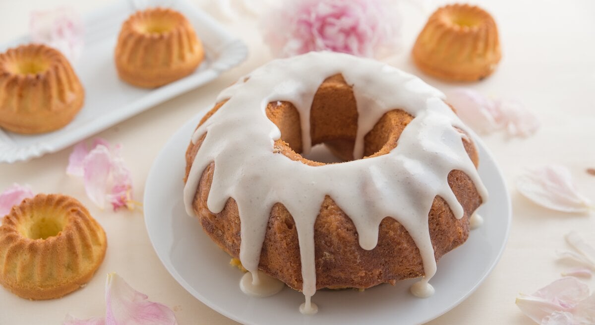 Gugelhupf-Eierlikörkuchen mit Glasur auf frühlingshaftem Tisch. 