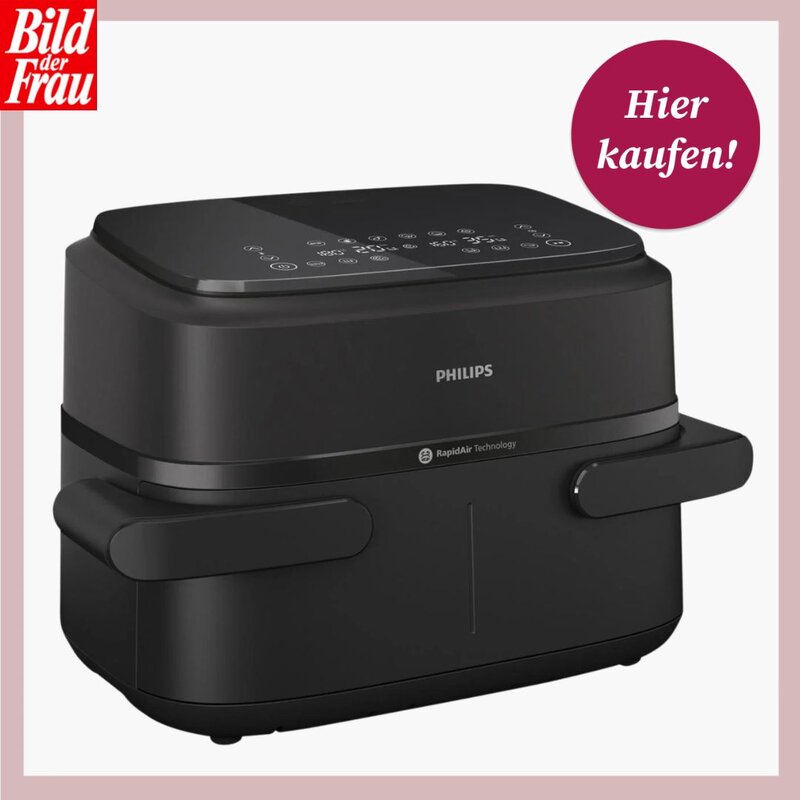 Schwarzer Philips Airfryer mit Touch-Bedienfeld auf der Oberseite und sichtbarem „RapidAir Technology“-Hinweis an der Front; freigestellt vor weißem Hintergrund, eingerahmt von einem roséfarbenen Rand. Links oben das „Bild der Frau“-Logo, rechts oben ein runder magentafarbener Störer mit der Aufschrift „Hier kaufen!“. Gerät in perspektivischer Nahaufnahme, Fokus auf Markenlogo, Bedienicons und kompakte, eckig-abgerundete Bauform. | © Philips via Lidl