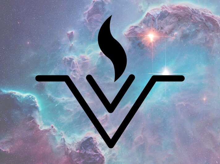 Das schwarze, astrologische Symbol des Asteroiden Vesta auf einem Hintergrund aus pastellfarbenem Weltraum-Nebel. Das Symbol besteht aus zwei V-förmig nach unten zeigenden Linien mit waagerechtem Abschluss, aus deren Mitte eine stilisierte Flamme emporsteigt. Der Hintergrund zeigt leuchtende Sterne und farbenreiche kosmische Wolken in Blau, Türkis und Violett. Die Darstellung wirkt mystisch und spirituell, möglicherweise in Verbindung mit astrologischen oder energetischen Konzepten. | © Visual Content und Vital Intent/ Jessica Aceret via Canva.com [M]
