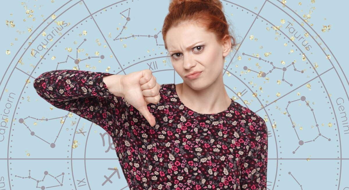 Junge Frau mit roten Haaren und floralem Oberteil, die mit einem unzufriedenen Gesichtsausdruck den Daumen nach unten zeigt. Im Hintergrund ist ein astrologisches Sternzeichenrad mit goldenen Glitzereffekten auf hellblauem Hintergrund zu sehen.