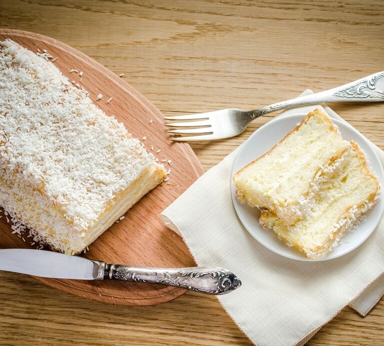 Angeschnittener heller Kastenkuchen mit Kokos | © Getty Images/AlexPro9500