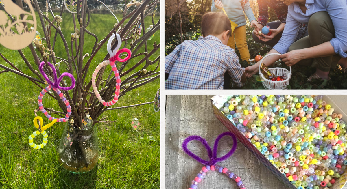 Bunter Osterstrauch in Glasvase auf grüner Wiese, geschmückt mit Perlenanhängern in Hasenform und Papierdeko im warmen Frühlingslicht.