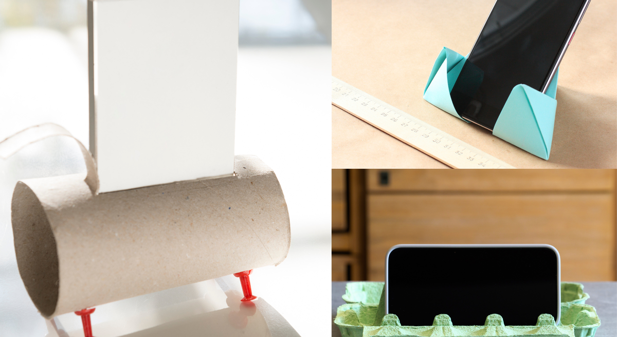 Drei Smartphones stehen in selbstgebastelten Haltern aus Toilettenrolle, Origami-Papier und grünem Eierkarton auf Tischen.