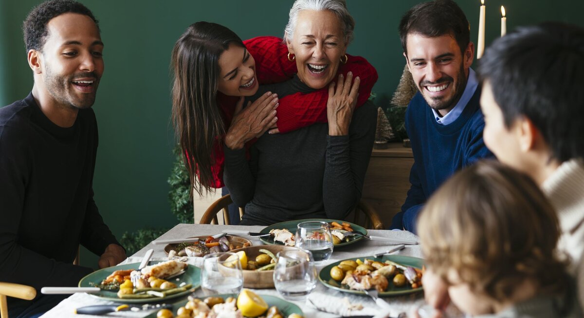 Zu sehen ist eine glückliche Familie an Weihnachten