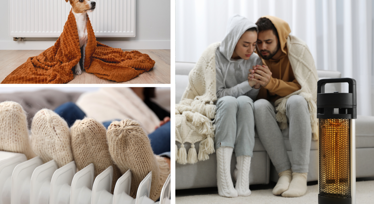 Junge Frau und Mann sitzen in Wollsocken und Decken gehüllt vor Heizstrahler, Hände wärmend, daneben Hund in Decke vorm Radiator.
