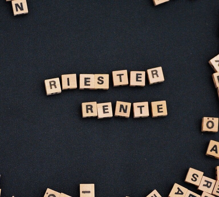 Zu sehen sind Scrabble Lettern, die die Wörter Riester Rente ergeben | © Shutterstock/ Maddas