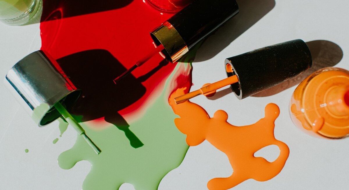 Zu sehen sind verschiedene Nagellackfarben, die teilweise ausgelaufen sind.
