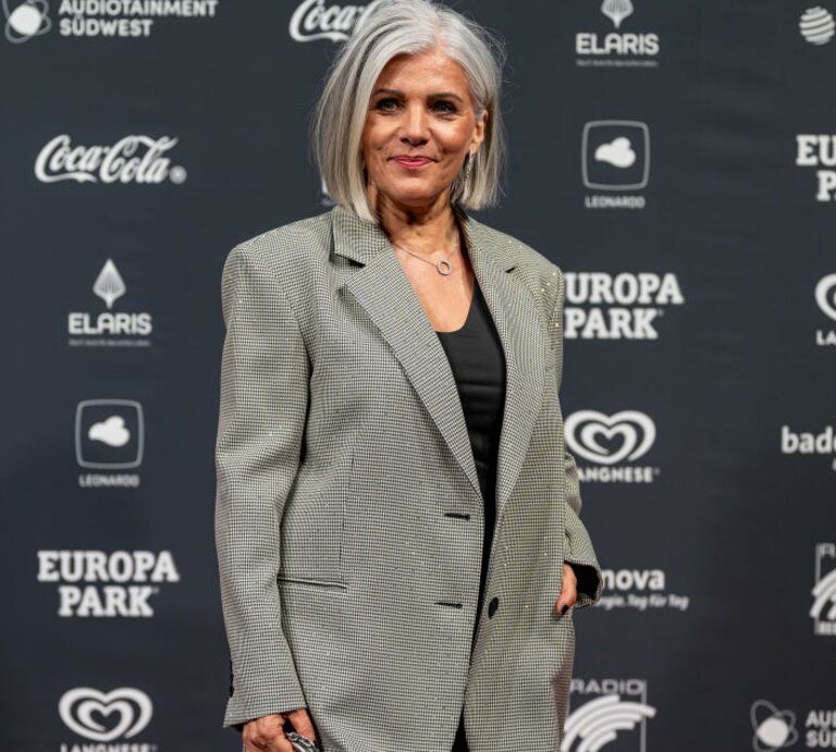 Birgit Schrowange vor einer Sponsorenwand | © Getty Images/ Simon Hofmann