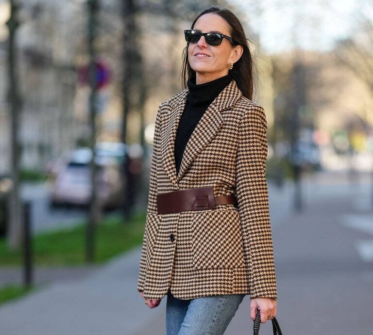 Zu sehen ist eine Frau mittleren Alters, die einen Blazer, einen Rollkragen und eine straight leg blue Jeans trägt | © Getty Images/Edward Berthelot