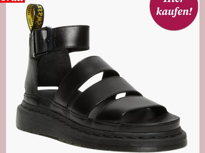 Stilvolle Dr. Martens-Sandale mit breiten, schwarzen Riemen und markanter gelber Fersenschlaufe. | © Dr. Martens