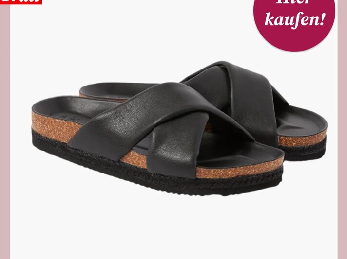Komfortable schwarze Sandalen mit breiten überkreuzten Riemen und dicker Korksohle, vor weißem Hintergrund. | © C&A