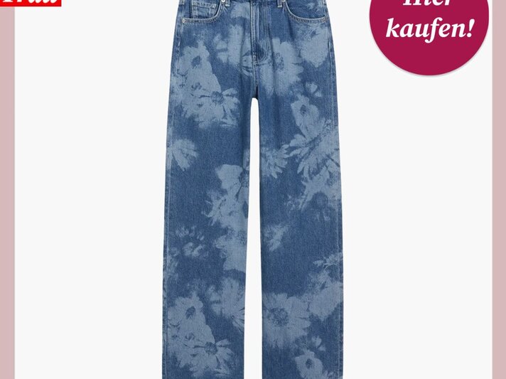  Das Bild zeigt eine Jeans mit einem floralen Muster, das über den gesamten Stoff verteilt ist. Die Farbgebung ist hauptsächlich in verschiedenen Blautönen gehalten, was auf einen Used-Look oder Acid-Wash-Stil hindeutet. Über dem Bild befindet sich das Logo "Bild der Frau" und rechts ein magentafarbener Kreis mit der Aufschrift "Hier kaufen!". Die Marke der Jeans ist "Clockhouse", wie auf dem Etikett am Bund zu erkennen ist. Diese Hose könnte eine stilvolle Ergänzung für eine Freizeitgarderobe sein und lässt sich vielseitig kombinieren. | © C&A