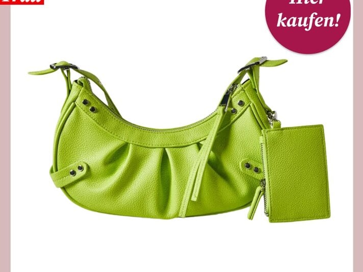 Das Bild zeigt eine lebendig hellgrüne Handtasche mit strukturiertem Stoff und Ziernähten. Die Tasche verfügt über einen verstellbaren Trageriemen und ist mit einer kleinen, passenden Geldbörse ausgestattet, die ebenfalls hellgrün ist und am Reißverschluss hängt. In der oberen linken Ecke des Bildes ist das Logo "Bild der Frau" platziert, und oben rechts befindet sich ein magentafarbener Button mit der Aufschrift "Hier kaufen!". Die Tasche ist vor einem rosa Hintergrund dargestellt, was den Farbkontrast betont und die Tasche als modisches Accessoire hervorhebt. | © C&A