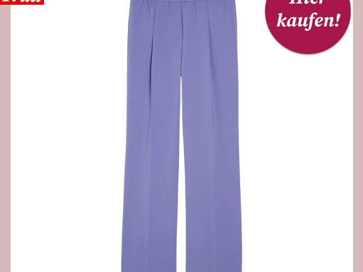 Das Bild zeigt eine elegante, gerade geschnittene Marlenehose in einem zarten Fliederton vor einem weißen Hintergrund mit rosa Umrandung. Die Hose hat einen elastischen Bund für zusätzlichen Komfort. In der oberen linken Ecke des Bildes ist das Logo "Bild der Frau" platziert, und oben rechts ist ein magentafarbener Button mit der Aufschrift "Hier kaufen!" zu sehen. Diese Hose könnte eine stilvolle Ergänzung für eine Business- oder Casual-Garderobe sein. | © C&A