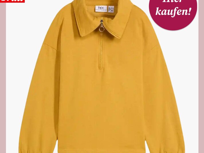 Modisches gelbes Sweatshirt mit halbem Reißverschluss, weitem Schnitt und schlichten, elastischen Ärmelabschlüssen. | © Bonprix